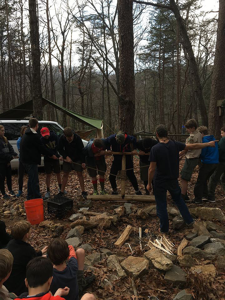 Attempting to start a fire by friction